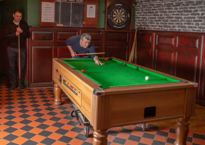 man playing pool